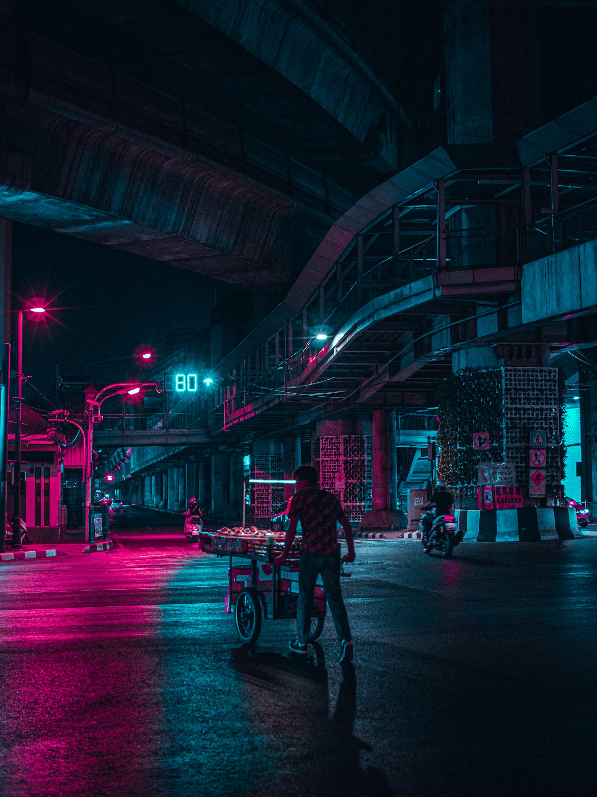 man in black jacket riding bicycle on road during night time