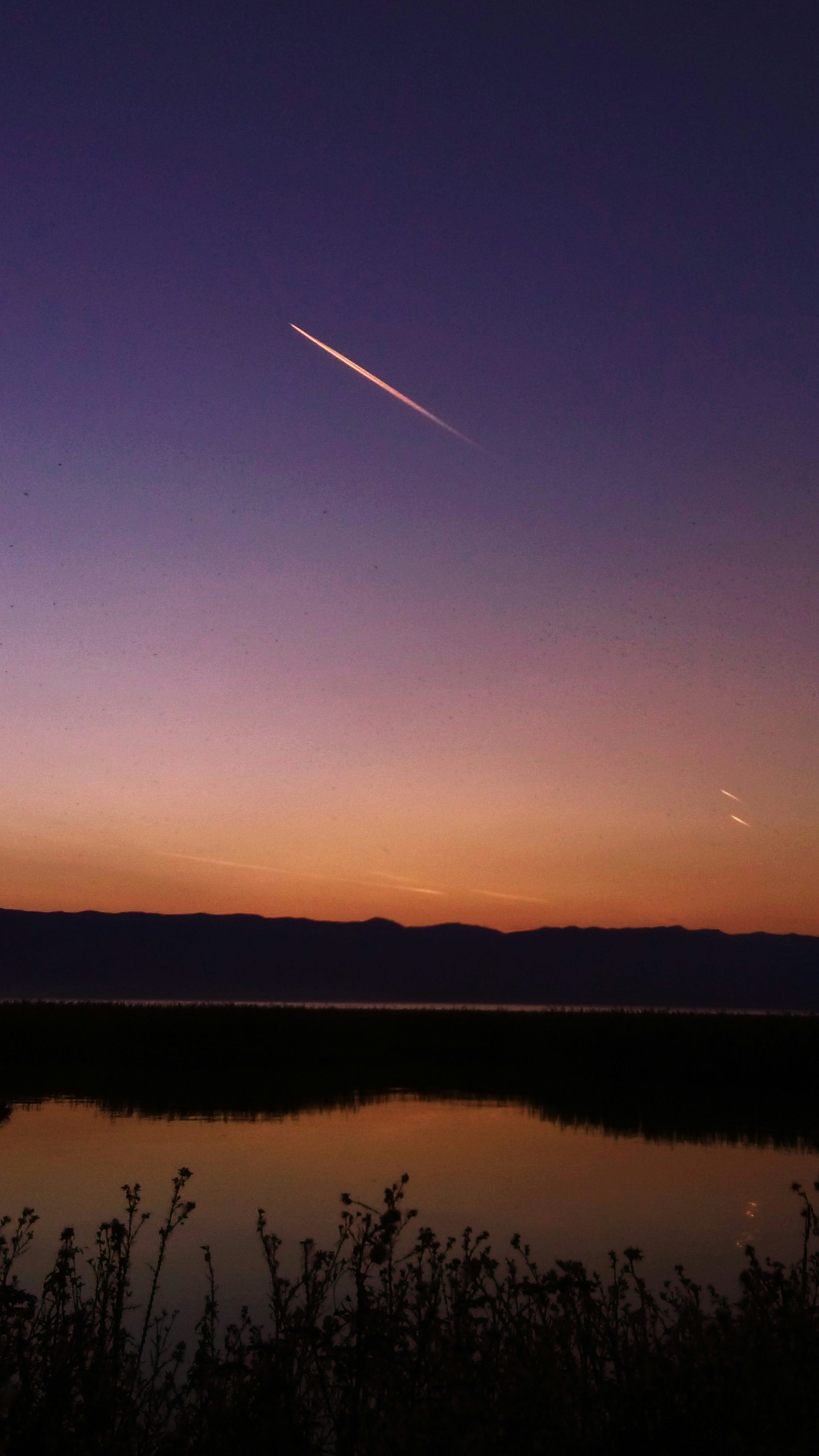 a plane is flying over a body of water