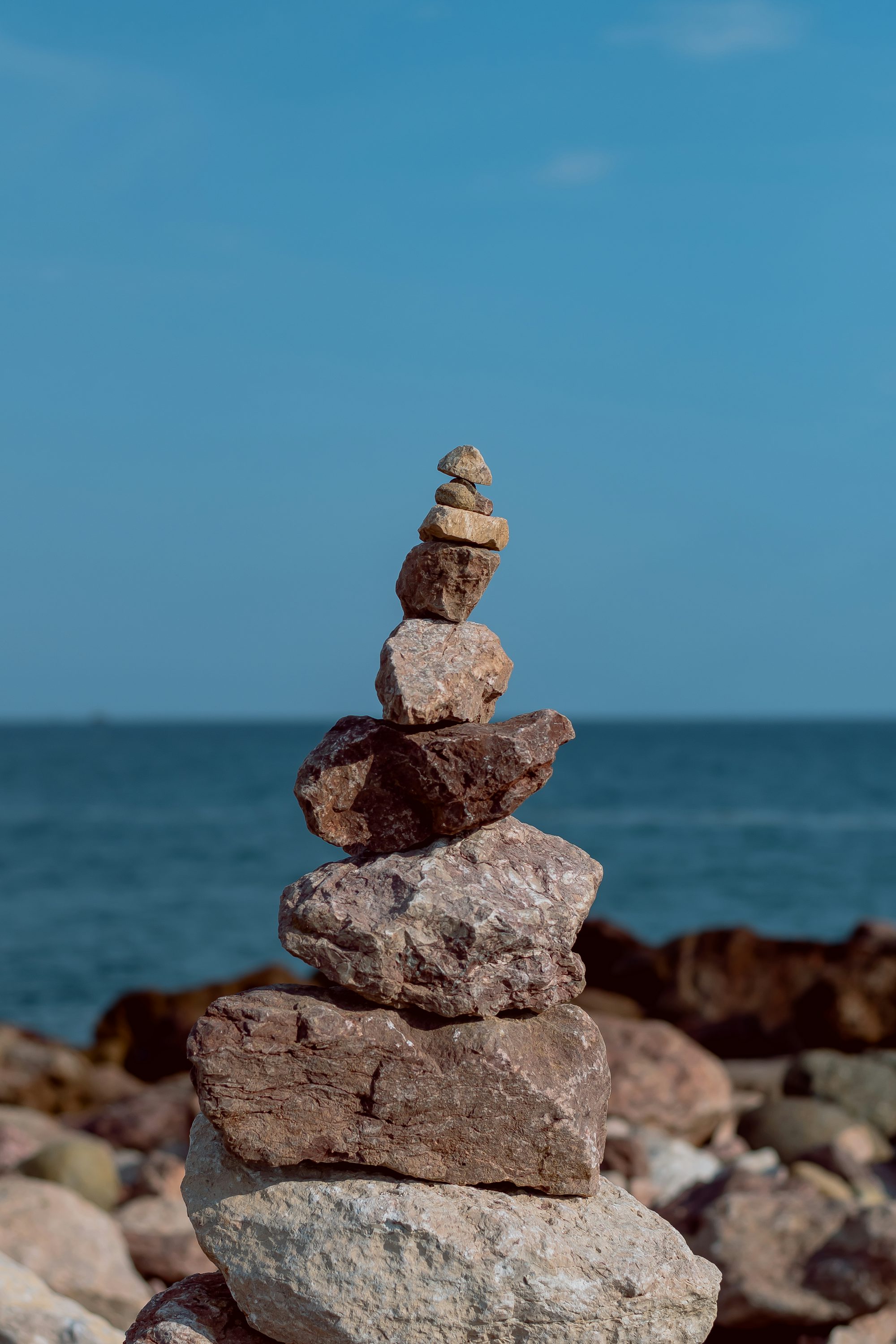 gray and brown stone near body of water during daytime