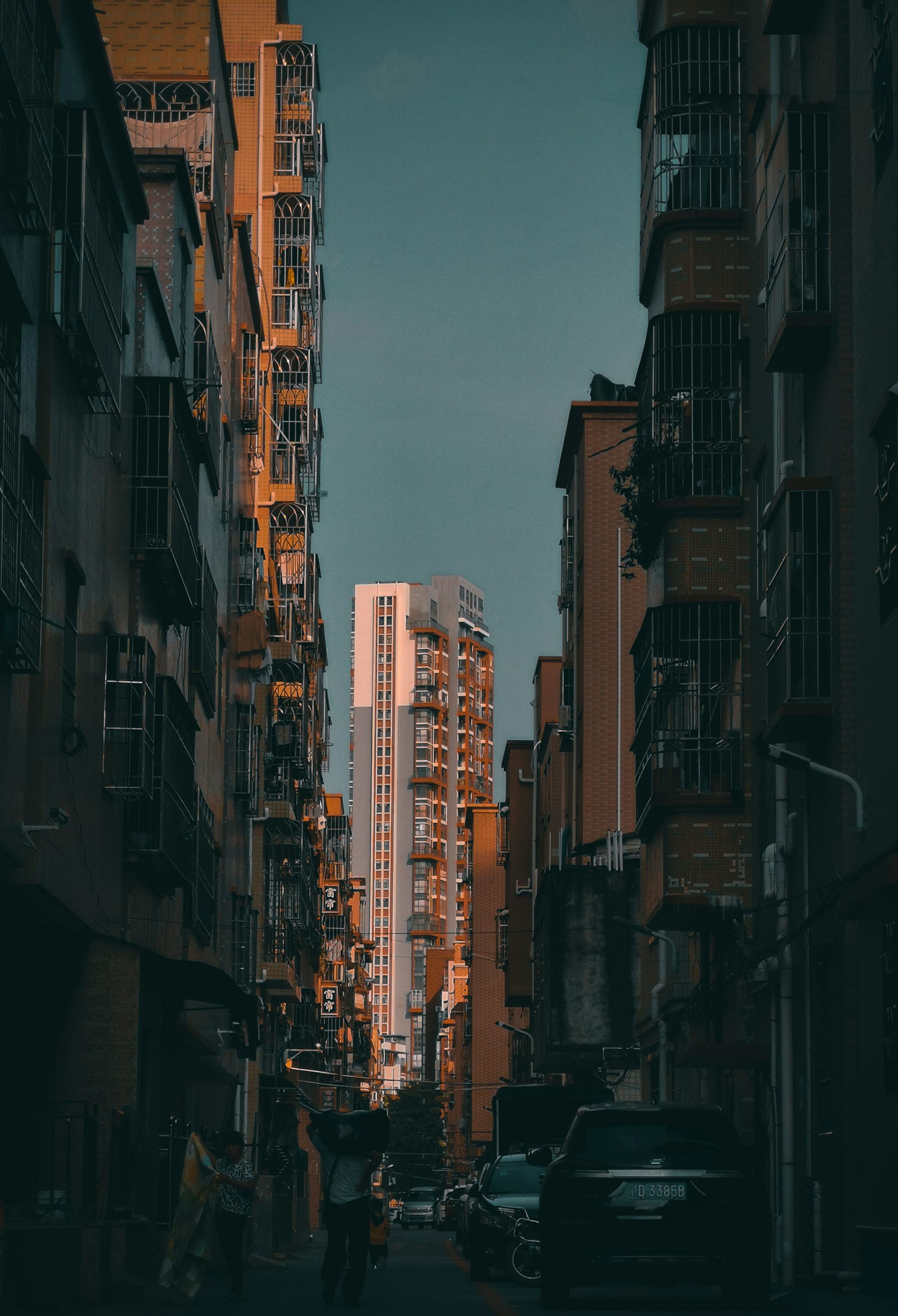 people walking on street between high rise buildings during daytime