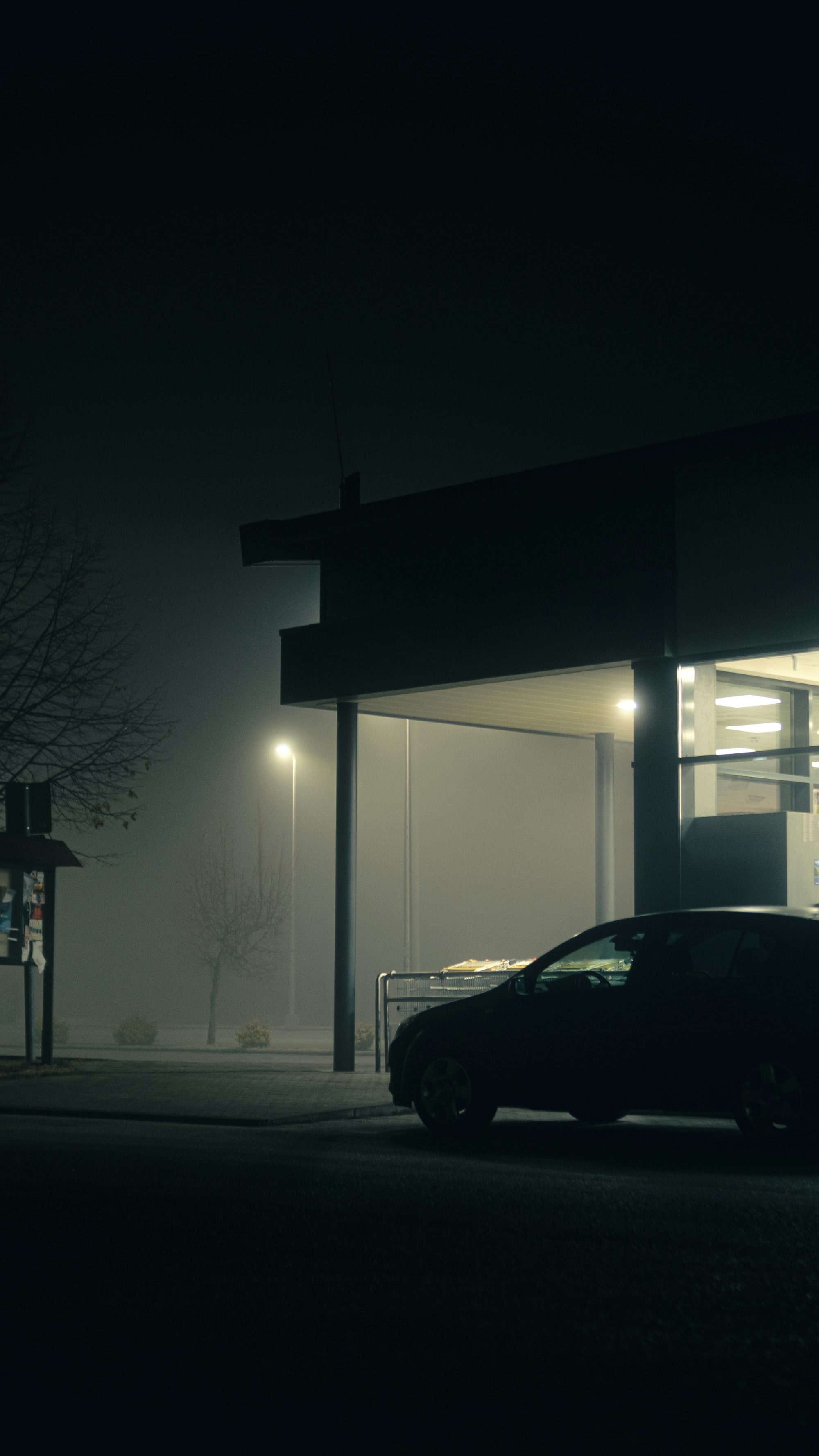 a car parked outside a building at night
