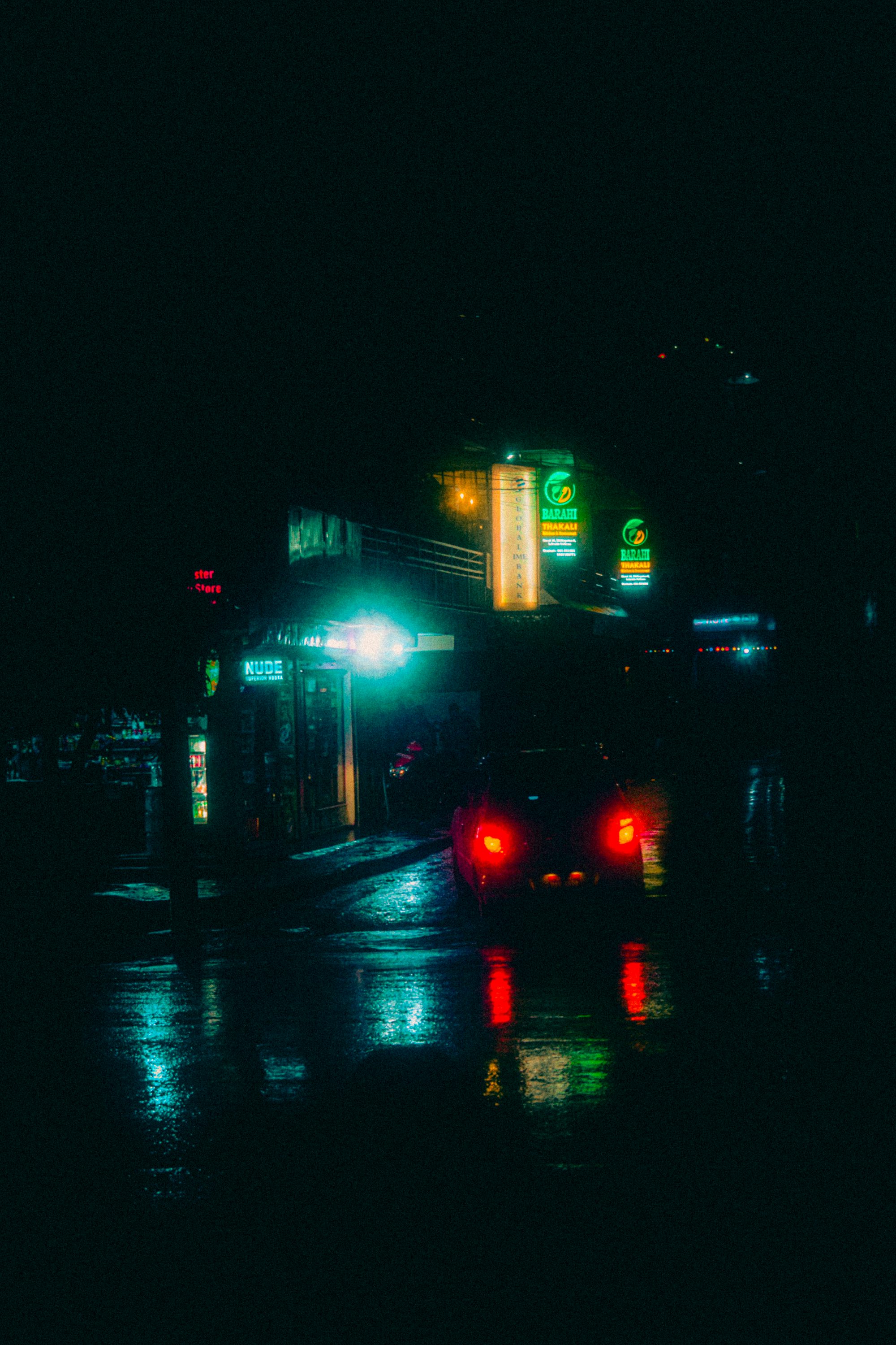 a city street at night with traffic lights