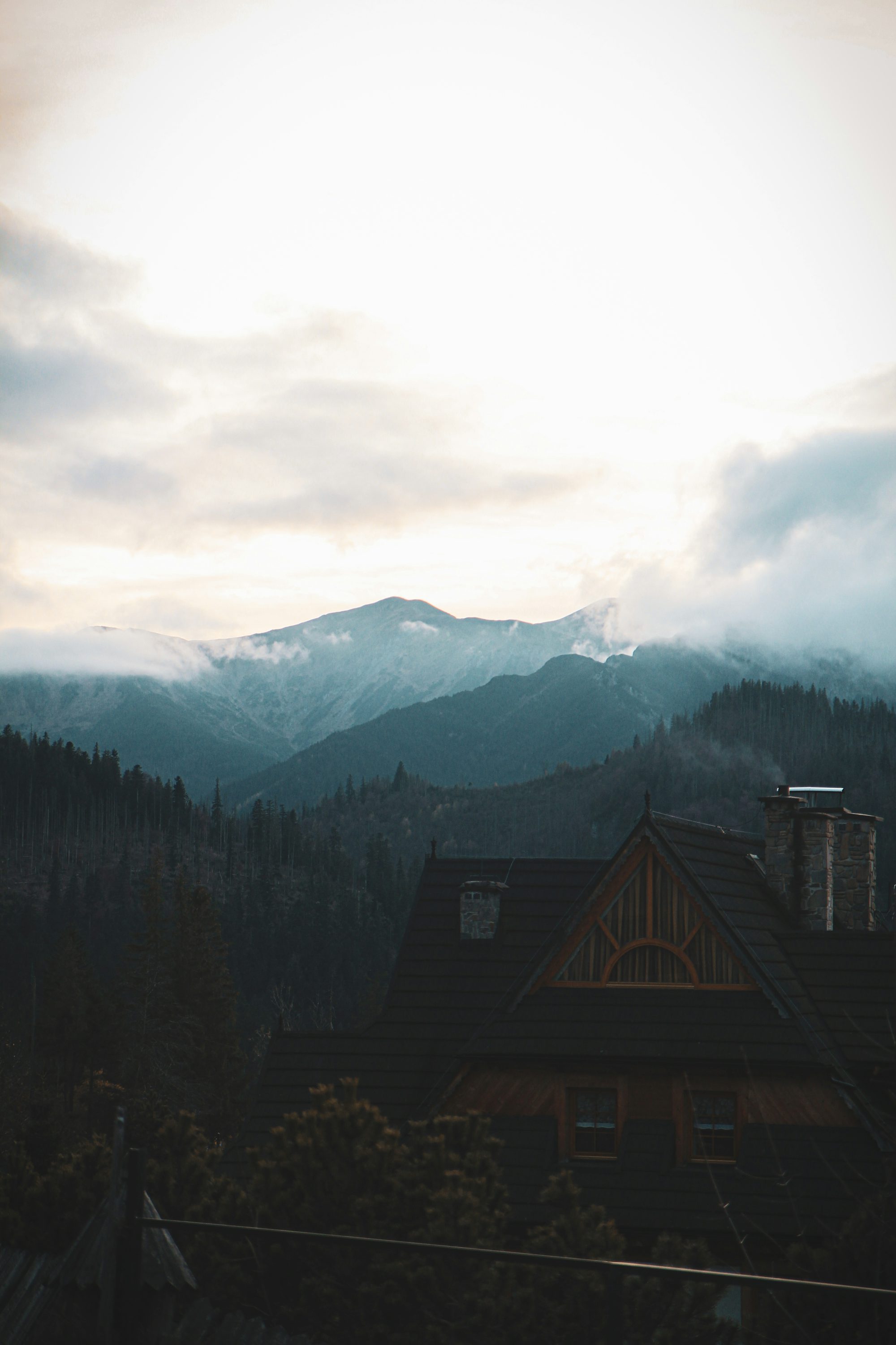 A view of a house with mountains in the background
